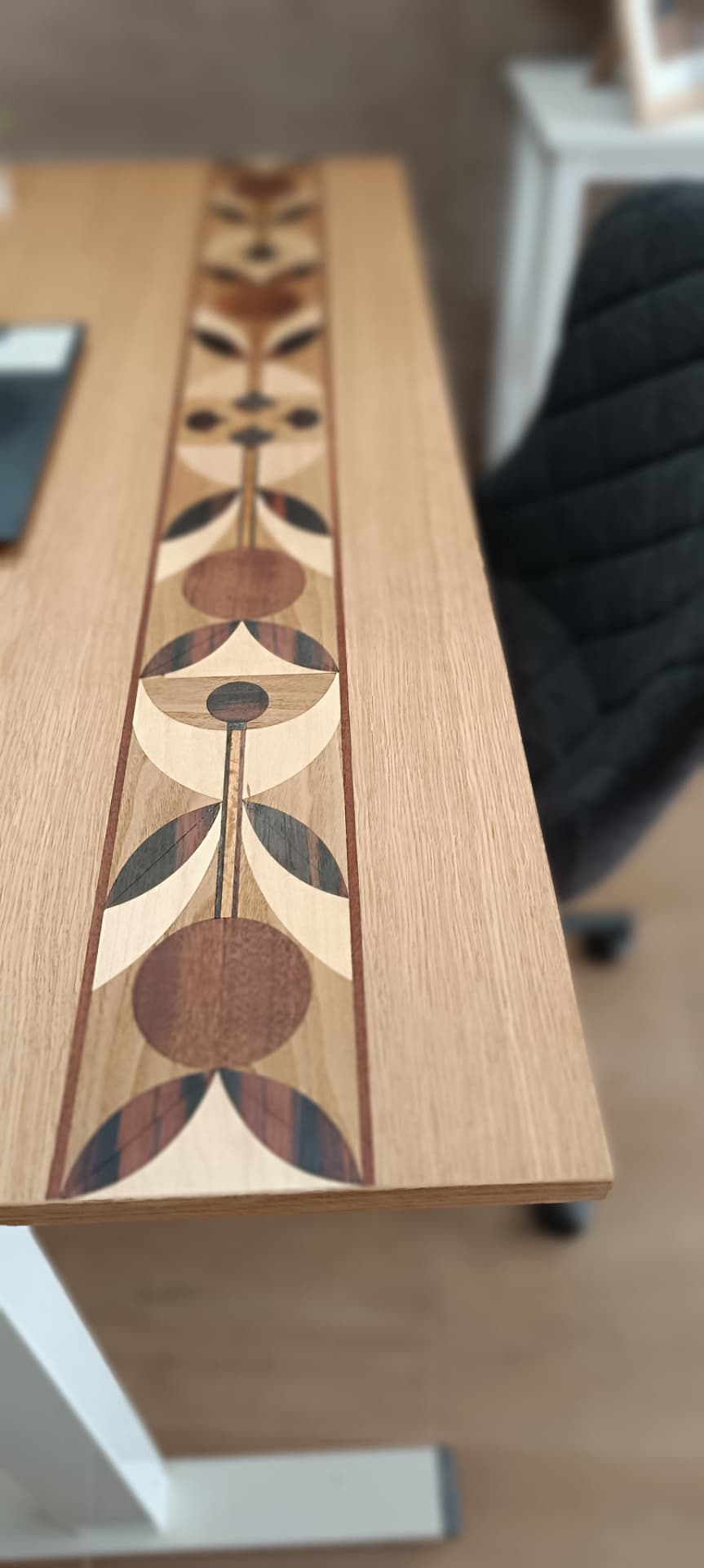 Marquetry desktop mounted on a sit-stand desk frame